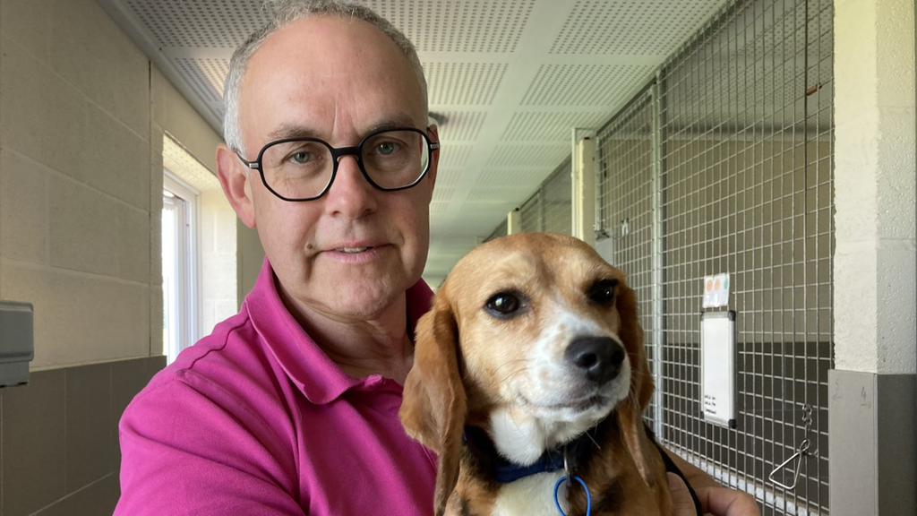 Carl Saunders holding a dog