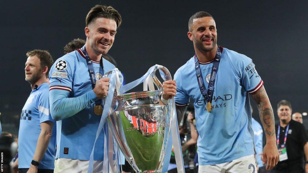 Jack Grealish and Kyle Walker with the Champions League trophy