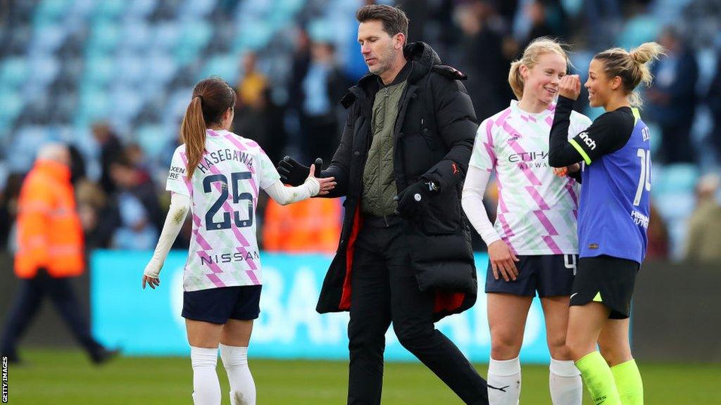 Manchester City women's manager Gareth Taylor shakes hands with players