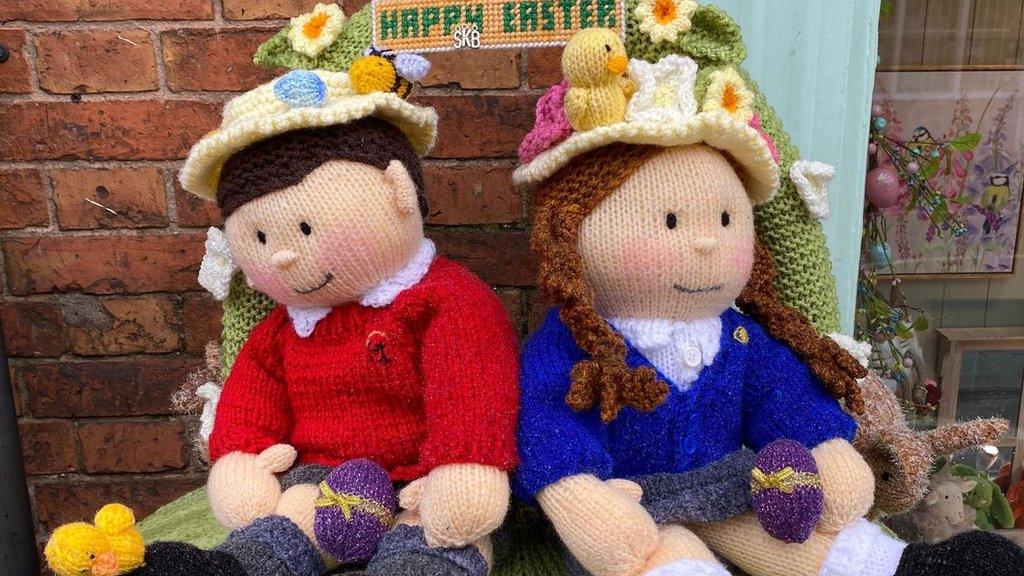 Knitted school children placed on top of Syston postbox