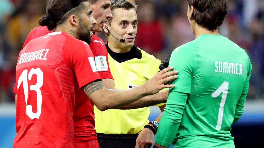 Referee Clement Turpin and Swiss players