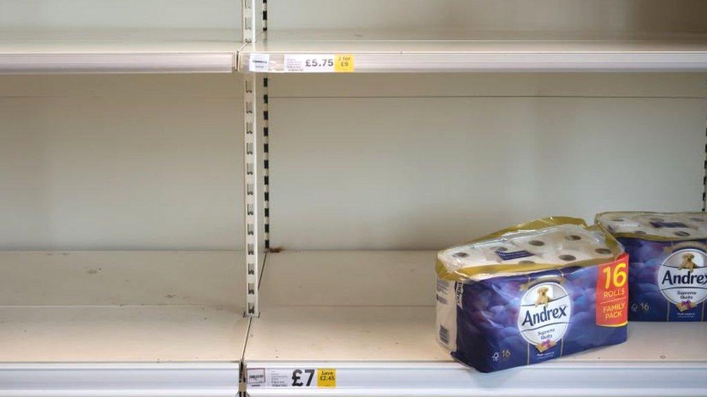 Empty shelf with one pack of toilet roll