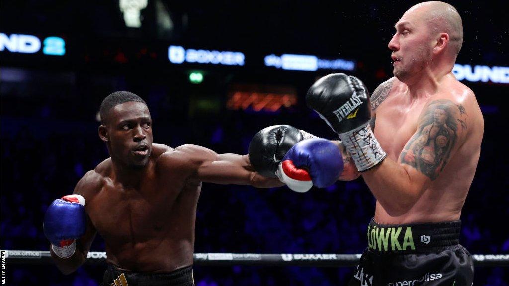 Richard Riakporhe (L) punches Krzysztof Glowacki