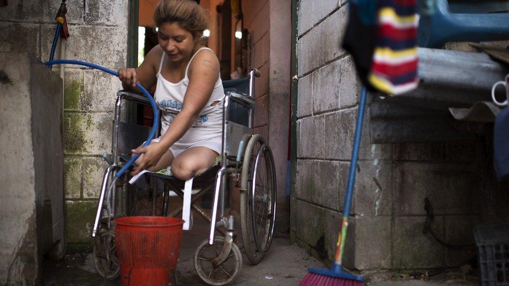 Mary, migrant from El Salvador, in a wheelchair