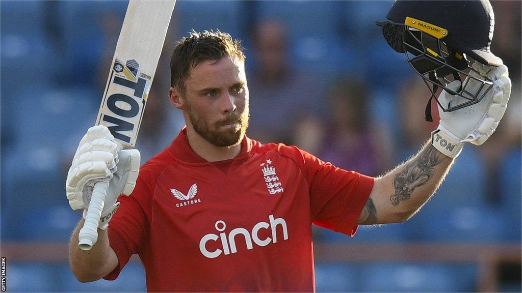 England batter Phil Salt raises his bat and helmet after hitting a century