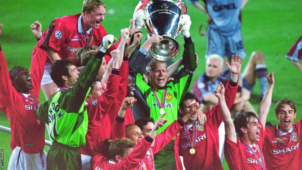 Manchester United players celebrate with the Champions League trophy