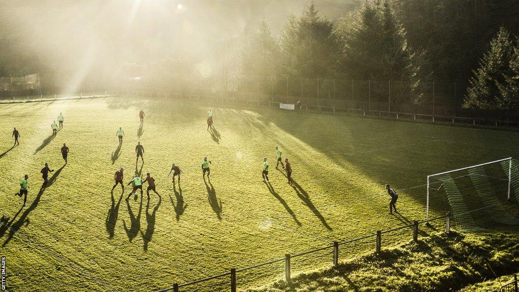 Action from a grassroots football match in Wales