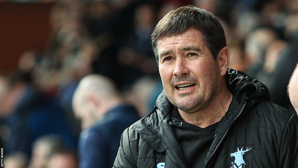 Mansfield boss Nigel Clough looks across the pitch during a game