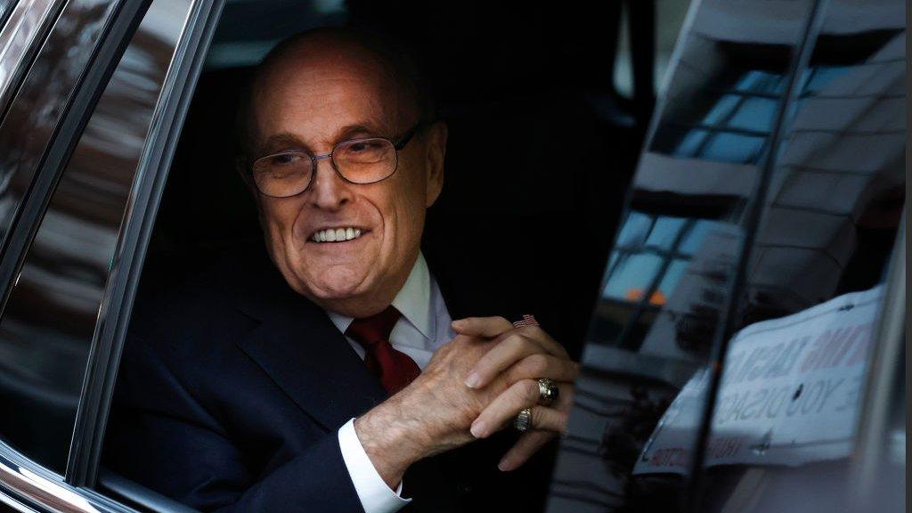 Mr Giuliani leaving the courthouse on Friday