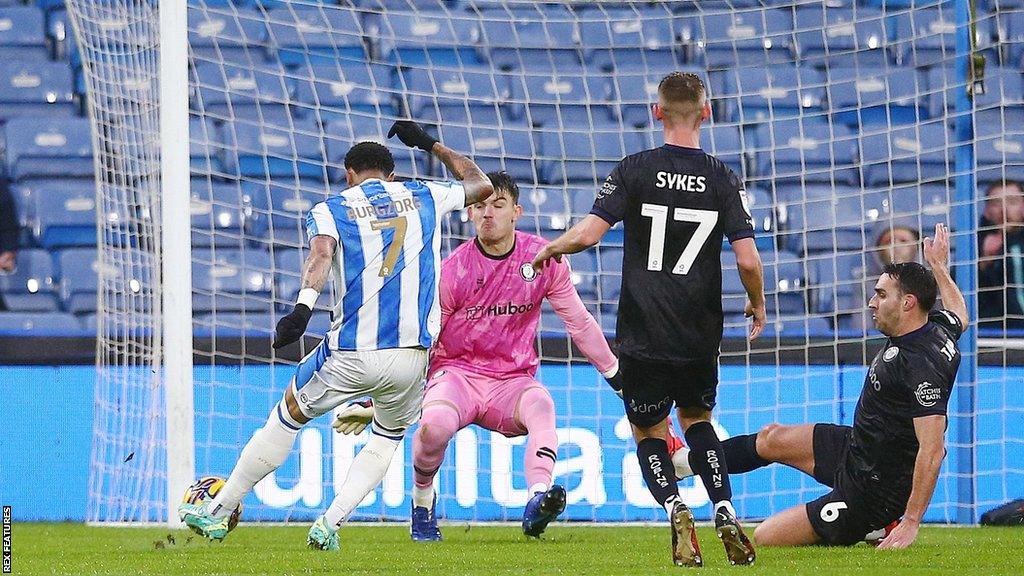 Delano Burgzorg of Huddersfield Town scores the opening goal against Bristol City