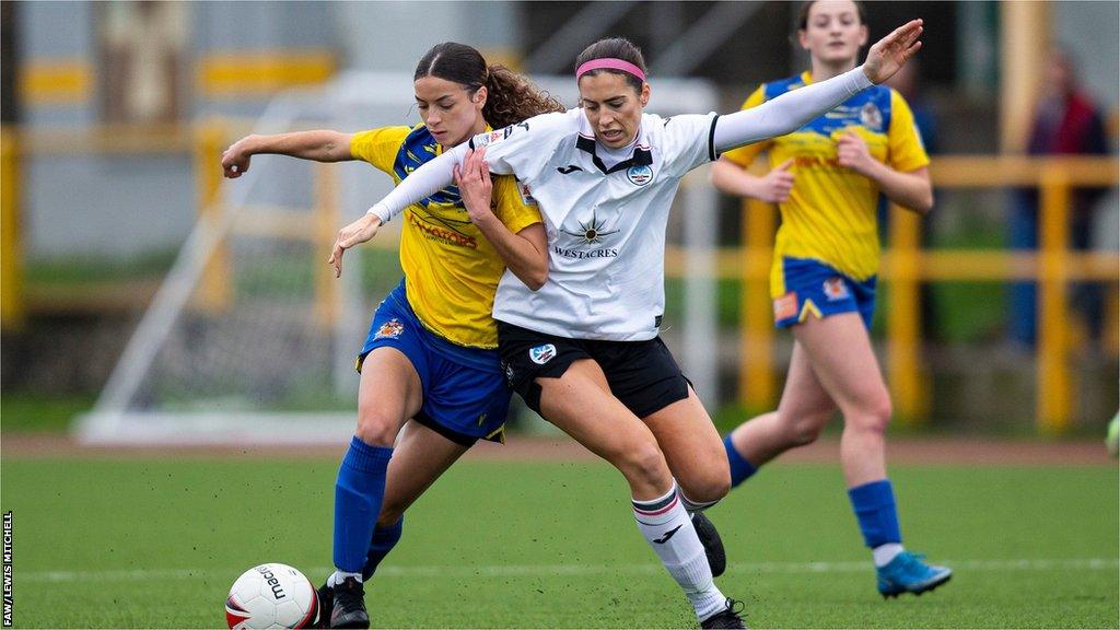 Maisy Fahey-Pennell of Barry Town in action against Swansea City's Katy Hosford