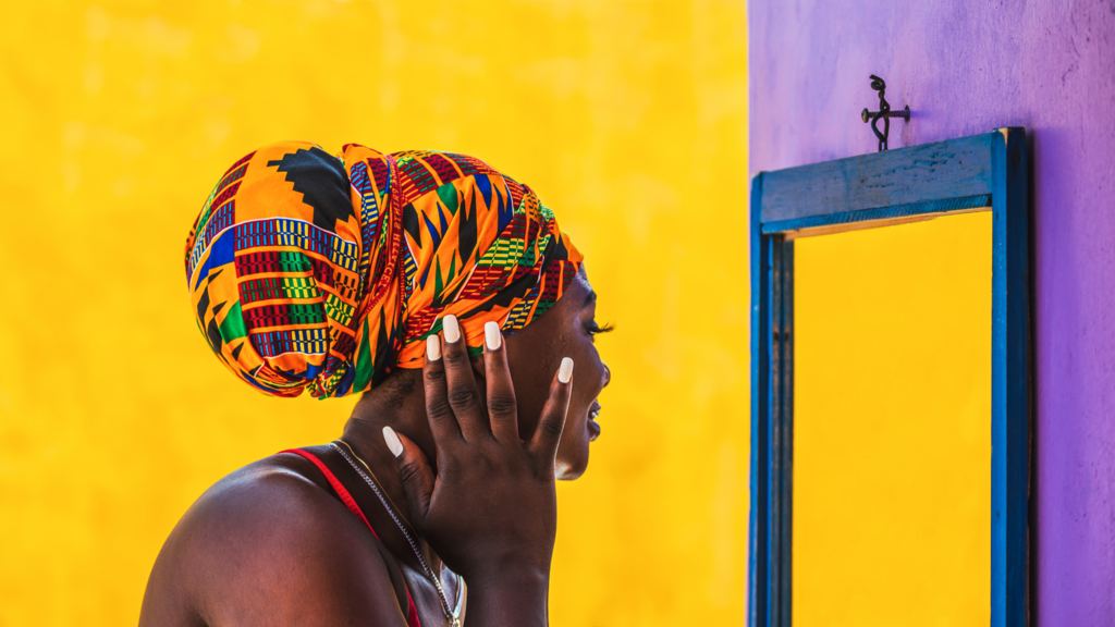 A woman looks into a mirror