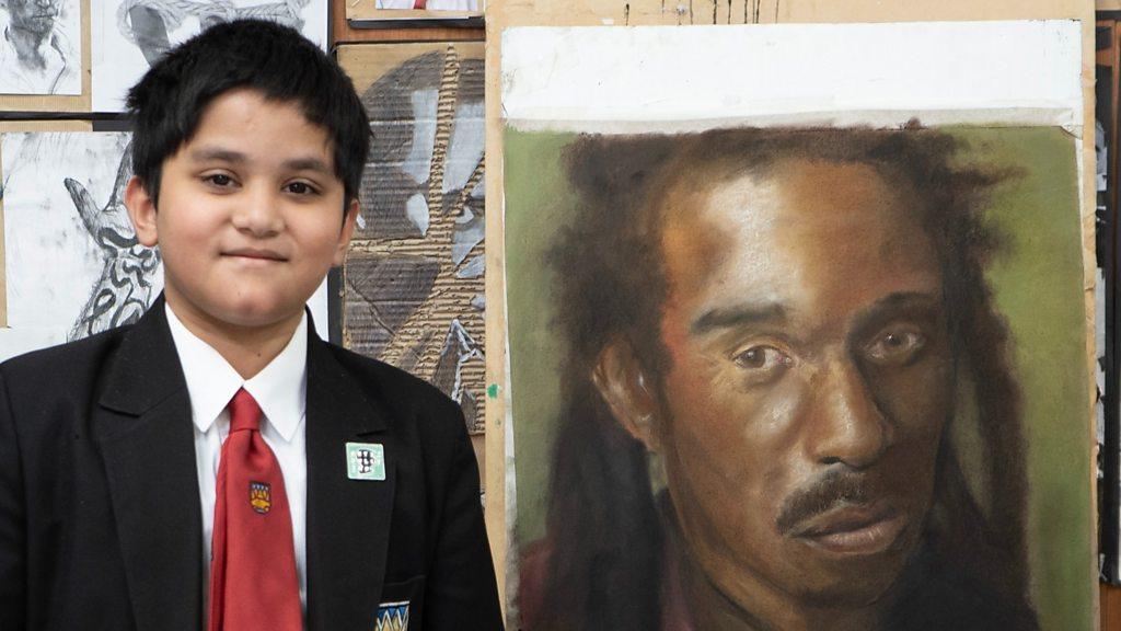 Izaan next to drawing of Benjamin Zephaniah