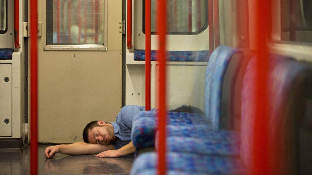 A man sleeps inside a London Underground
