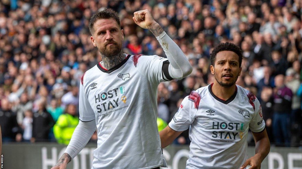 Sonny Bradley (left) raises his fist after scoring a goal