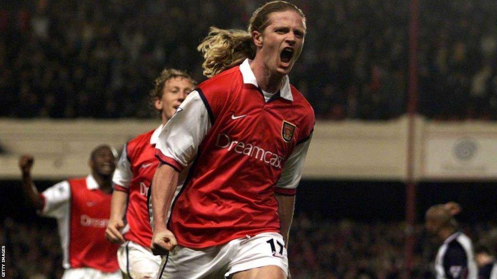 Emmanuel Petit celebrates while playing for Arsenal