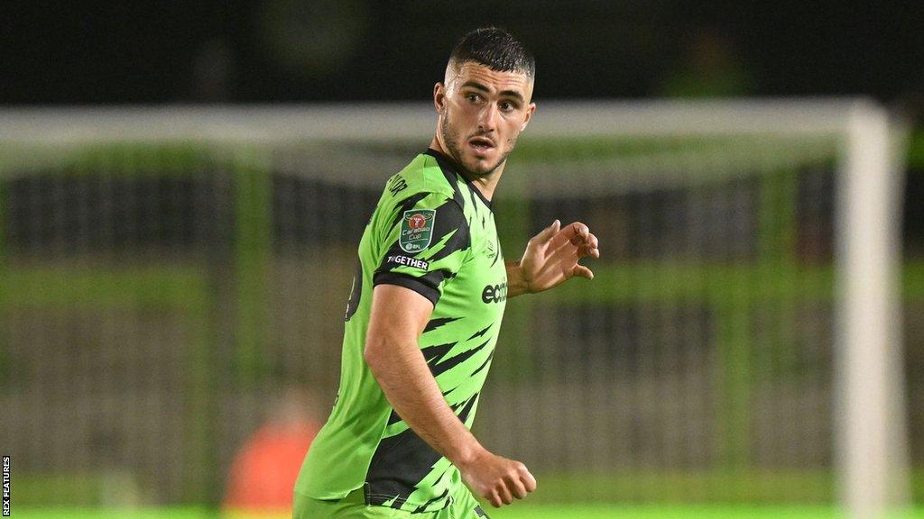 Jordan Moore-Taylor runs with the ball during a match for Forest Green