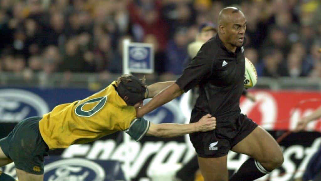 Jonah Lomu fends off Wallaby Stephen as New Zealand play Australia