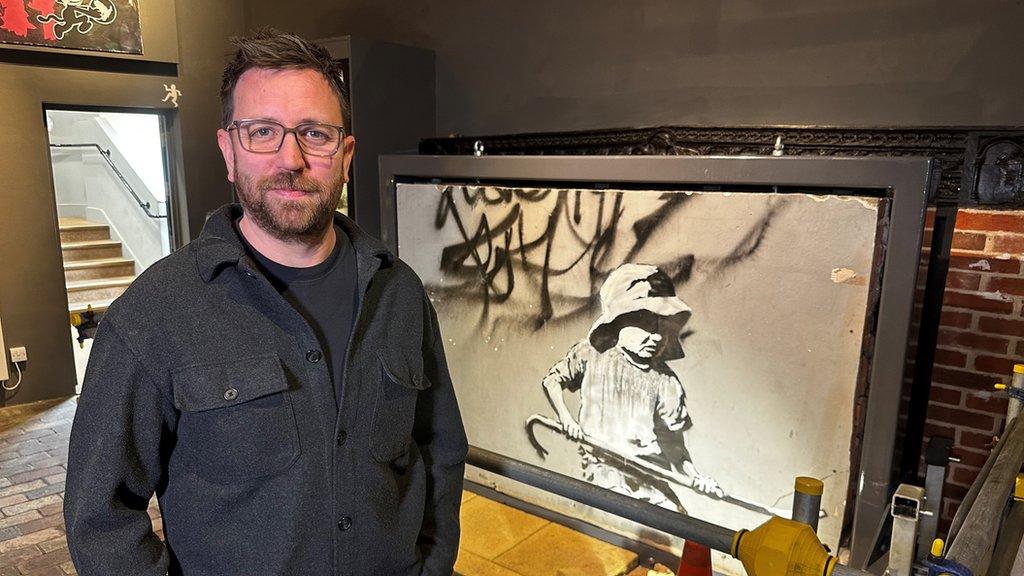 Dan Clarke stood in front of the Sandcastle Girl street artwork