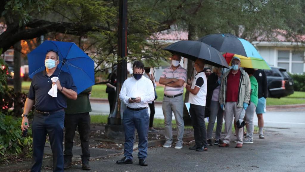 People in Florida queue in the rain to vote