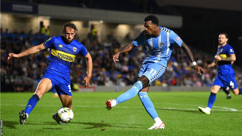 Wimbledon's Joe Lewis (left) and Coventry's Haji Wright