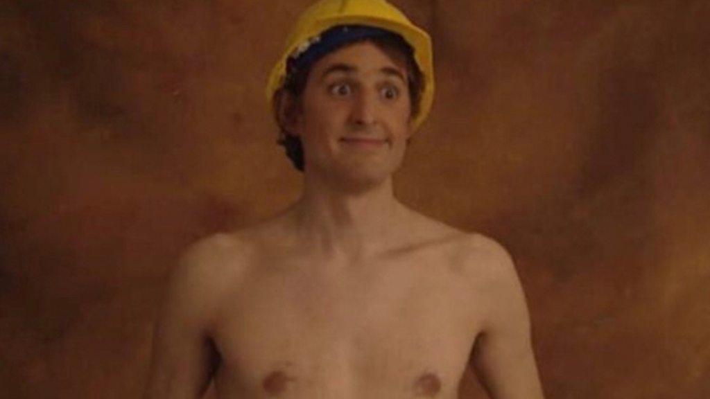 Louis Theroux, wearing a hard hat but no t-shirt.