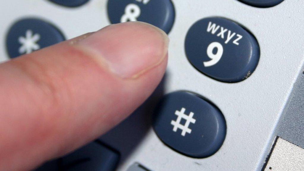 Finger pressing the nine button on a phone