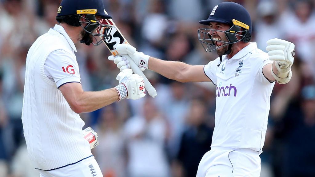 England's Chris Woakes (left) and Mark Wood (right) celebrate victory