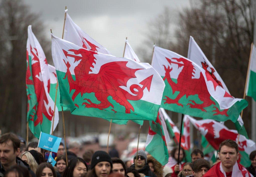 People waving Welsh flags on St David's Day