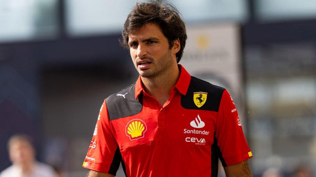 Carlos Sainz wearing a Ferrari shirt