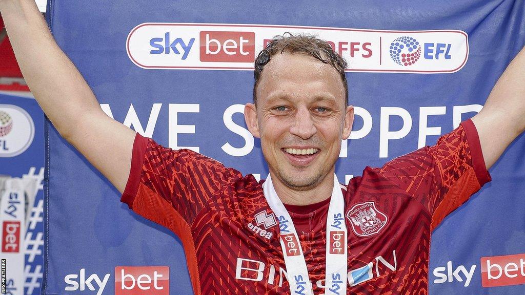 Kristian Dennis helped Carlisle United win promotion to League One through the play-offs in his final game for the club