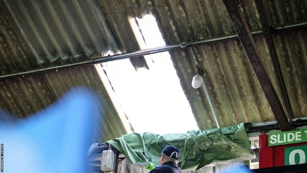 Workmen inspect the Main Stand roof at the Abbey Stadium