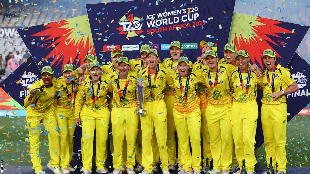 Australia celebrate with the trophy after winning the Women's T20 World Cup