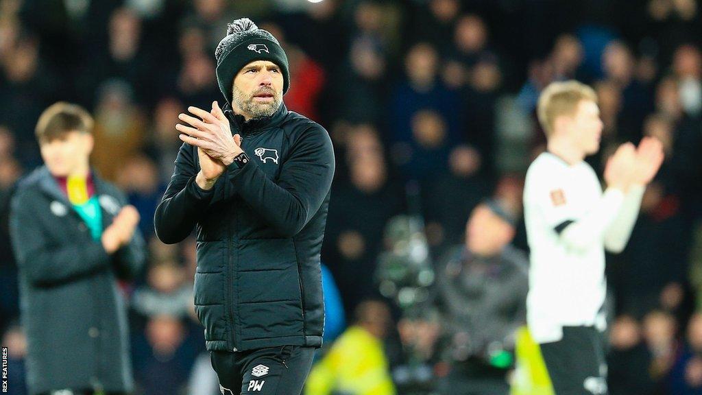 Derby County boss Paul Warne applauds the club's fans after a game