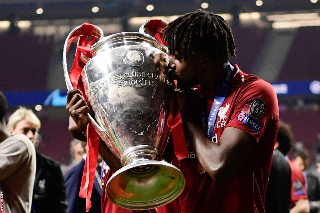 Divock Origi kisses the Champions League trophy