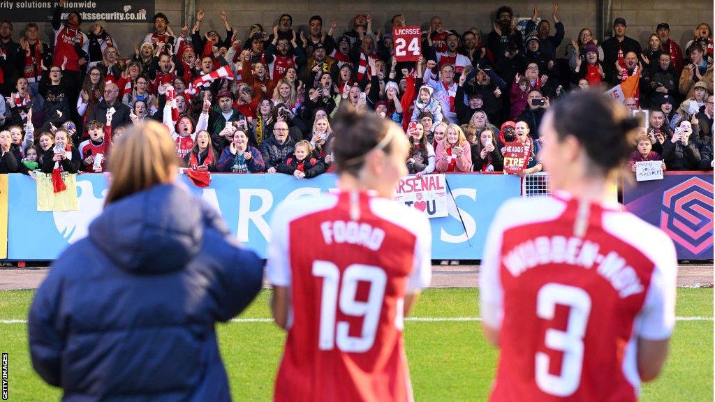 Arsenal fans show their support following the team's victory during the Barclays Women's Super League football match between Brighton & Hove Albion and Arsenal FC at Broadfield Stadium