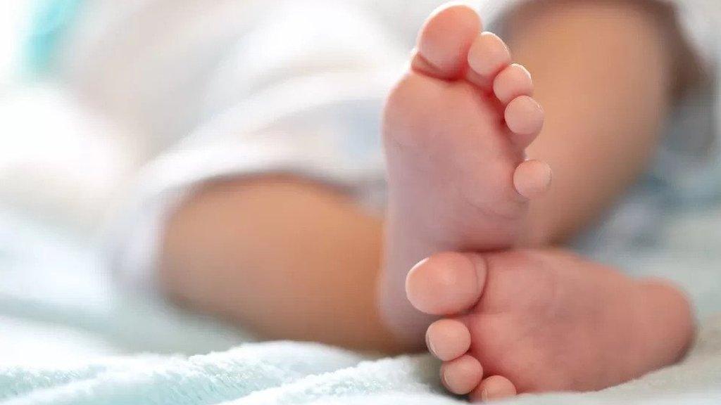 The feet of a new born child