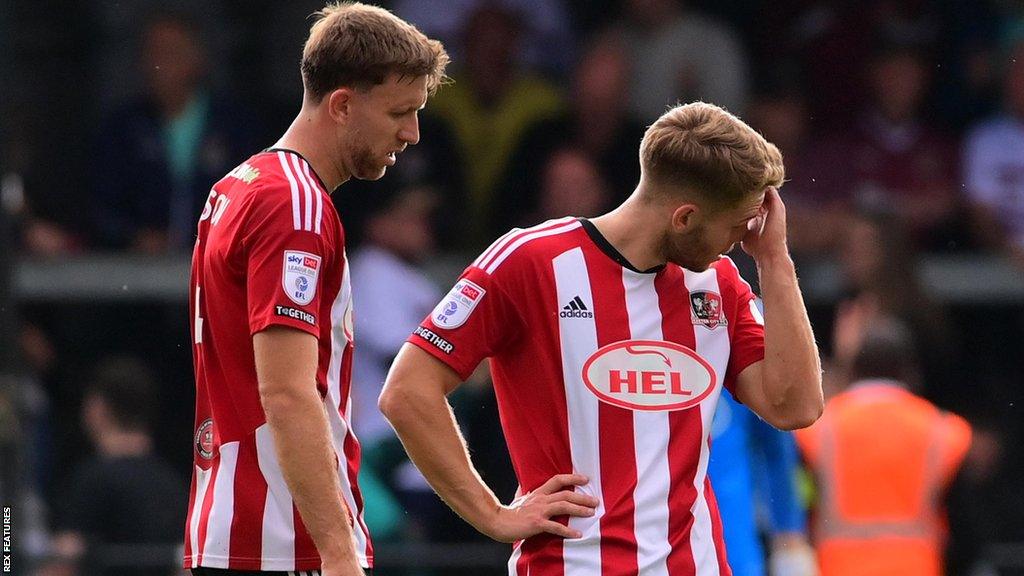 Exeter City players look unhappy after conceding a goal