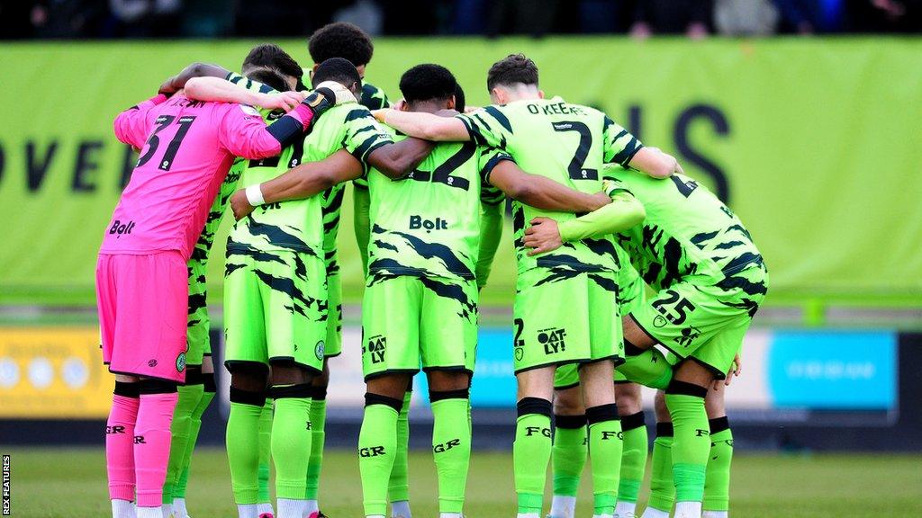 Forest Green players in a huddle during a match