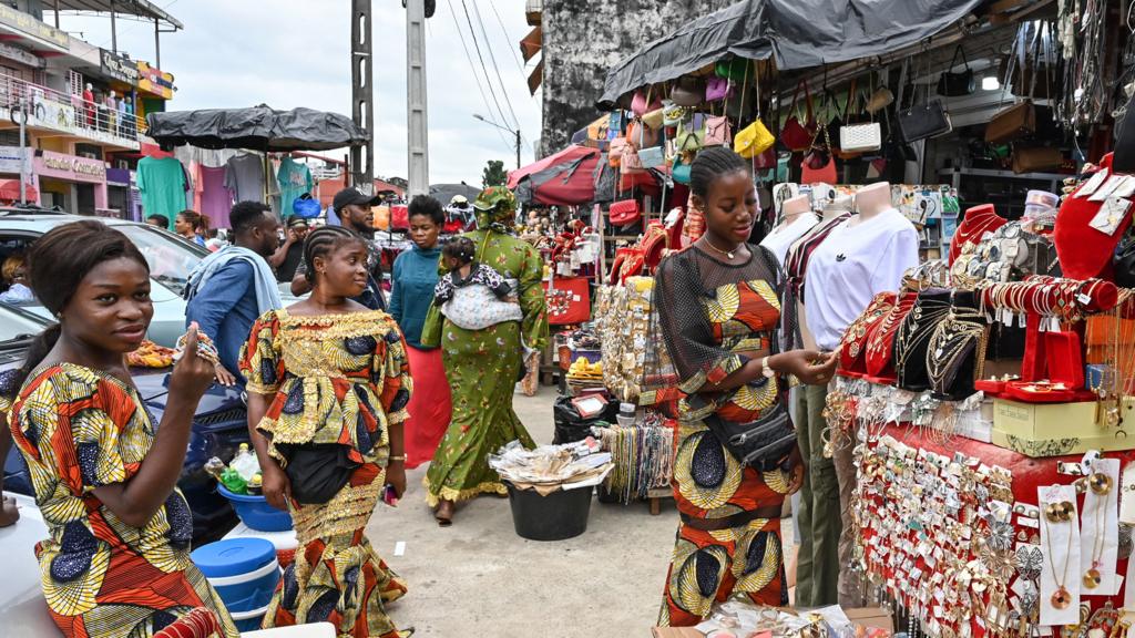 People shop at the Cocovico market in Abidjan, Ivory Coast - 27 June 2023