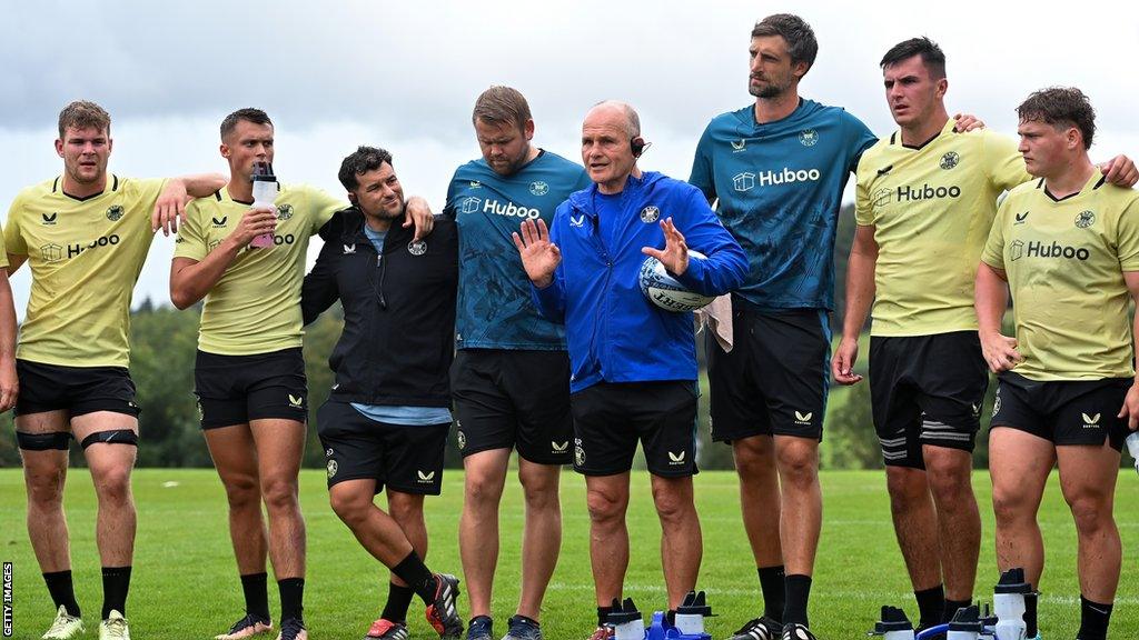 Andy Robinson (fourth from right) in a circle of Bath players and coaches during a training session