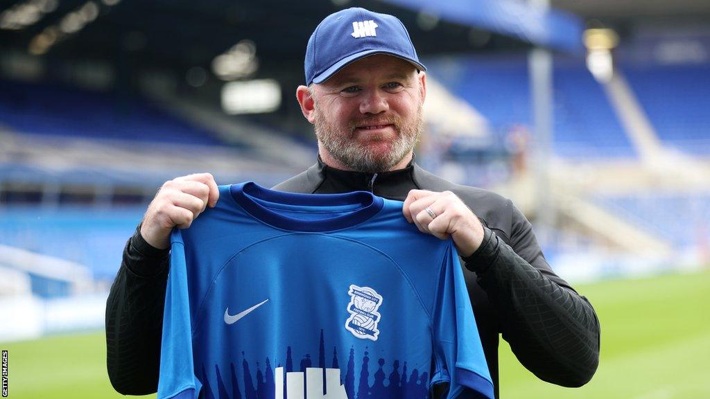 Birmingham City manager Wayne Rooney poses with a club shirt