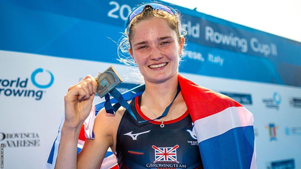 Olivia Bates holds her bronze medal draped with the Great British flag