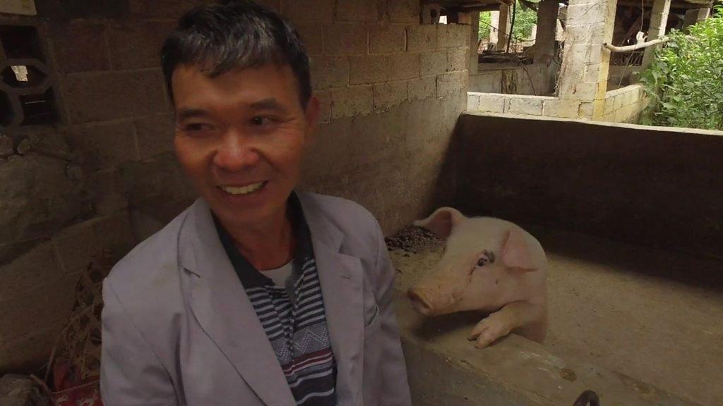 pig farmer and his one surviving pig