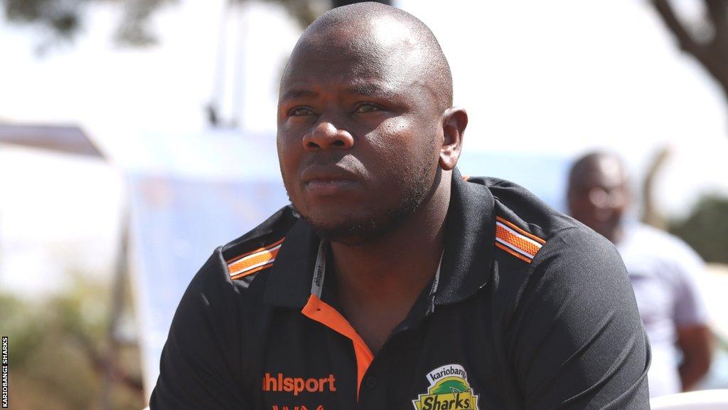 William Muluya wears a Kariobangi Sharks training shirt while looking thoughtful