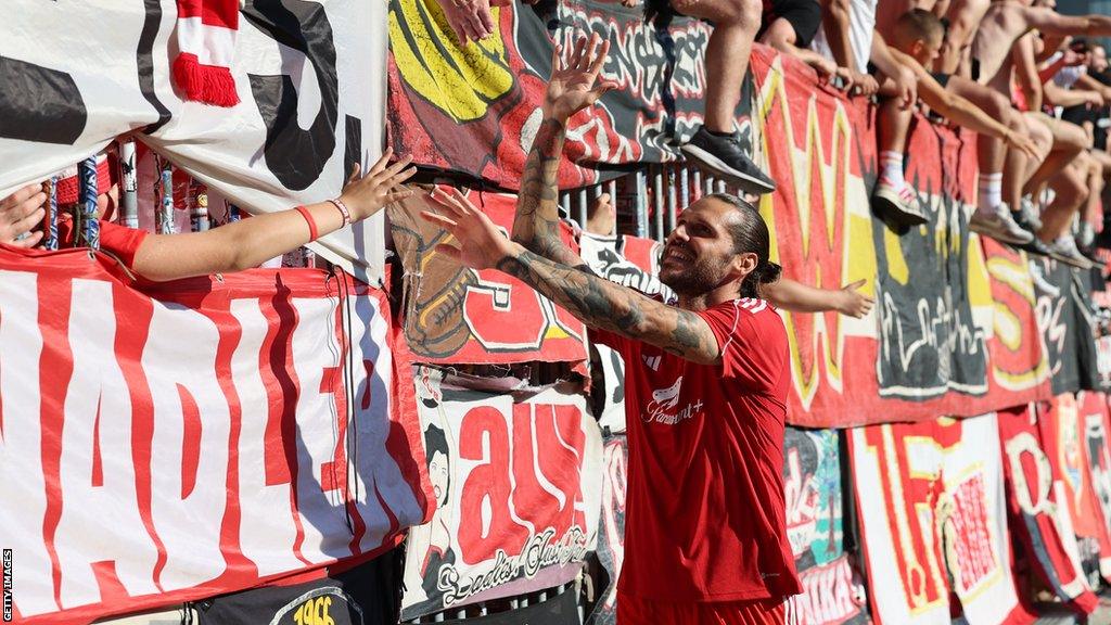 Christopher Trimmel of Union Berlin celebrates with fans