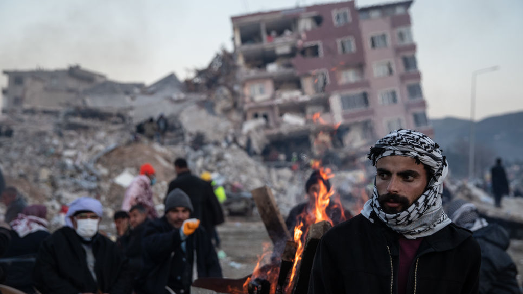 People wait for news of their loved ones, believed to be trapped under collapsed buildings on February 09, 2023 in Hatay, Turkey