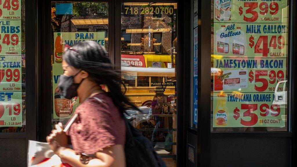 Woman walks by grocery store