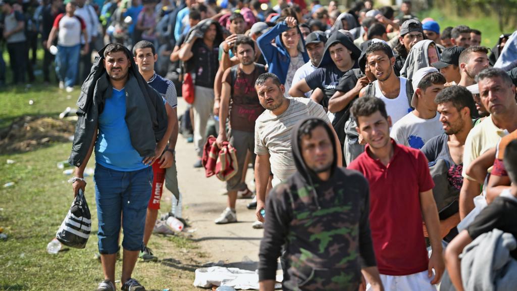 Migrants wait to board busses at Tovarnik railway station following crossing from Serbia in Tovarnik, Croatia - September 18, 2015