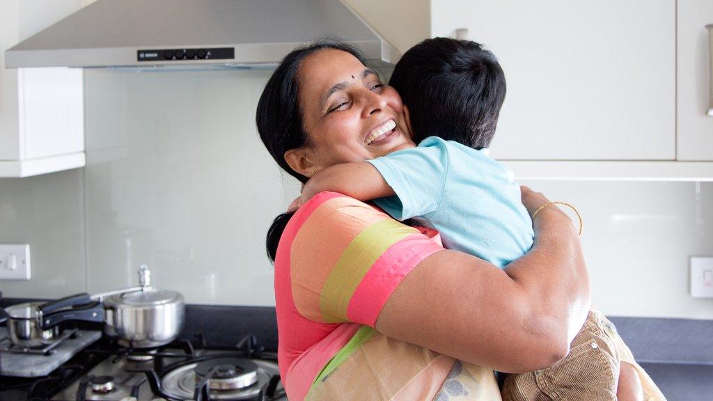 Woman in sari hugging her grandchild